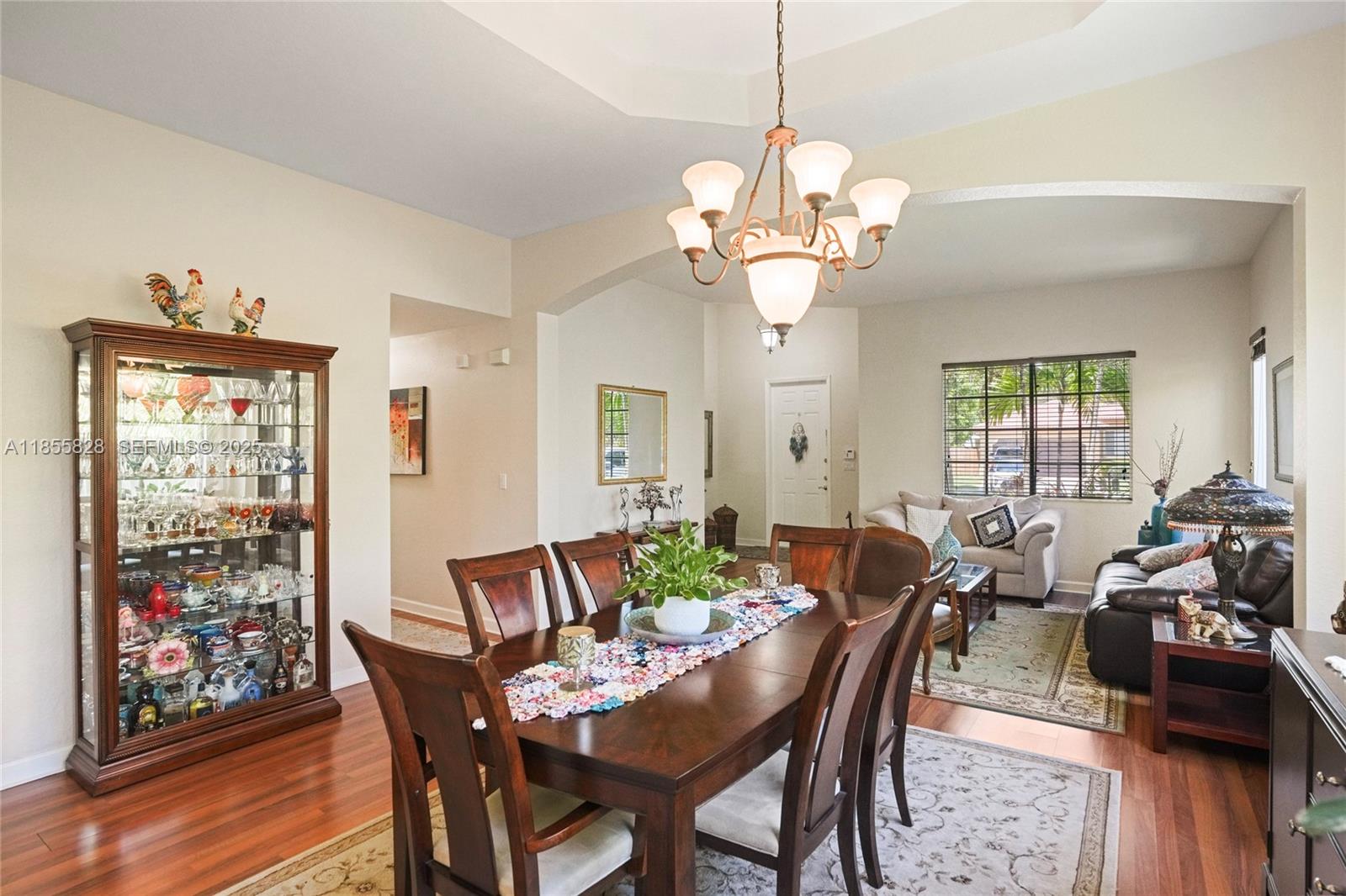9506 Southwest 220th Lane Cutler Bay, FL 33190 - Photo 46 of 51 a view of a dining room with furniture wooden floor and chandelier