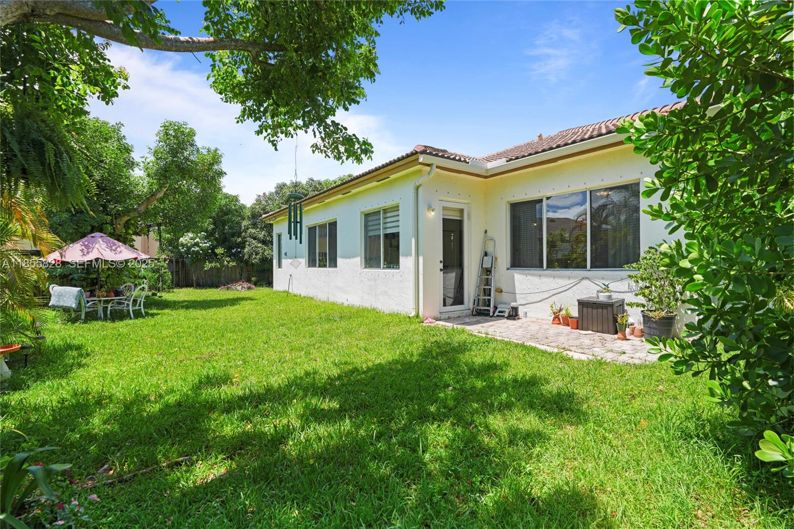 9506 Southwest 220th Lane Cutler Bay, FL 33190 - Photo 48 of 51 a view of a house with backyard porch and garden