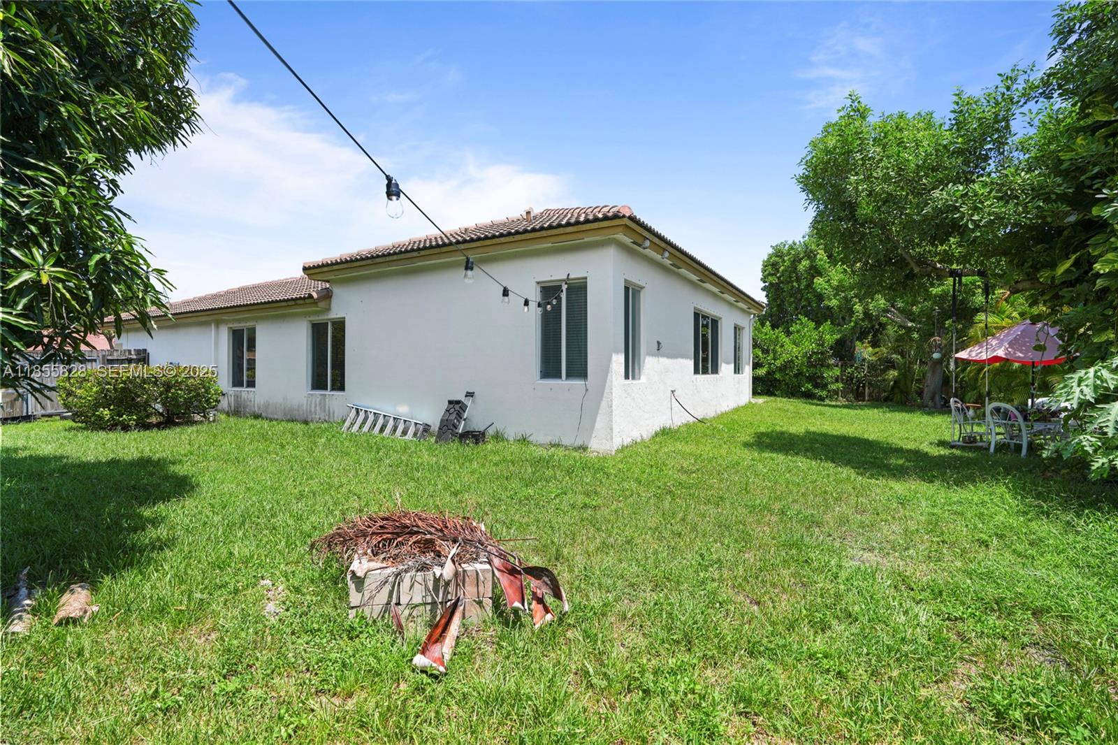9506 Southwest 220th Lane Cutler Bay, FL 33190 - Photo 50 of 51 a front view of house with yard and green space
