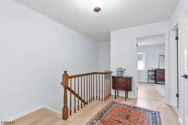 a view of a hallway with a livingroom and a window
