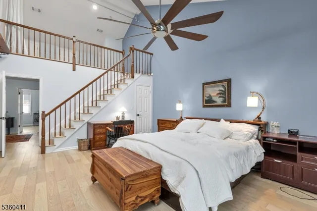 a bedroom with bed and a chandelier