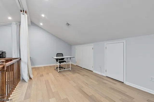 a view of a livingroom with a table and chairs