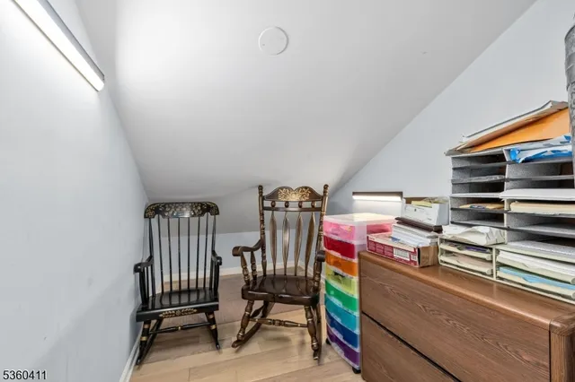 a storage room with water heater and racks on the wall