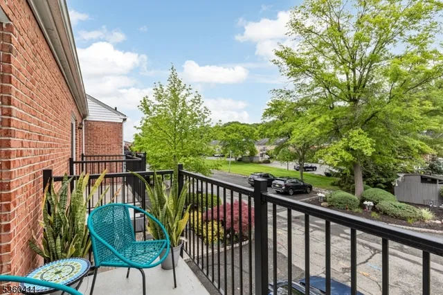 a view of a chair and table in the balcony