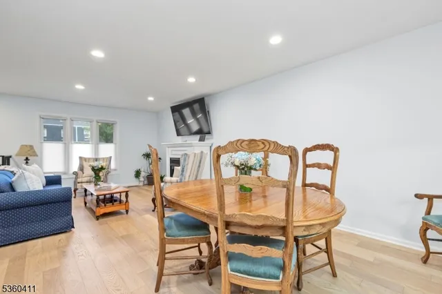 a living room with furniture and a dining table
