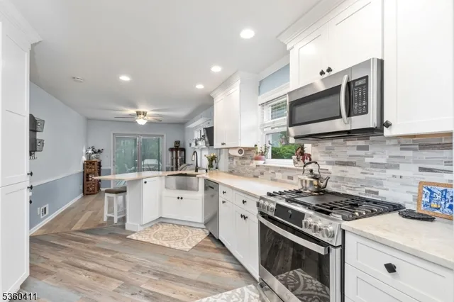 a kitchen with a stove sink and microwave