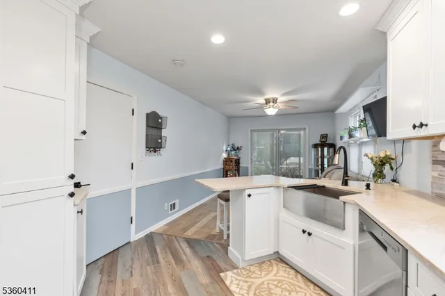 a kitchen that has a sink and a stove in it