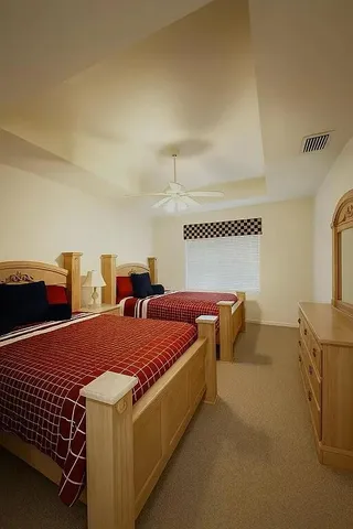 a bedroom with two beds and painted walls