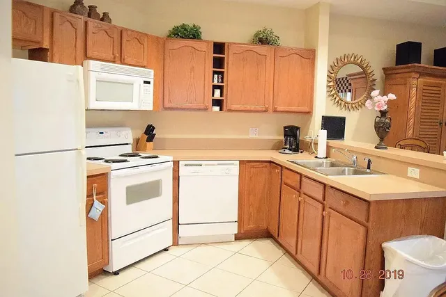 a kitchen with a sink cabinets and appliances