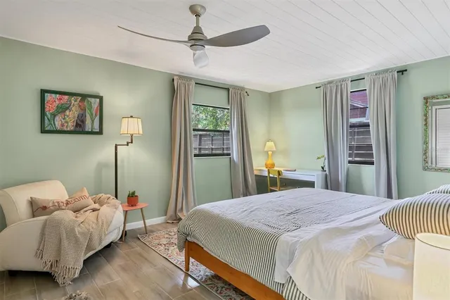 a bedroom with a bed and a chandelier