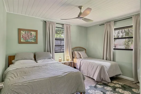 a bedroom with two beds and a window
