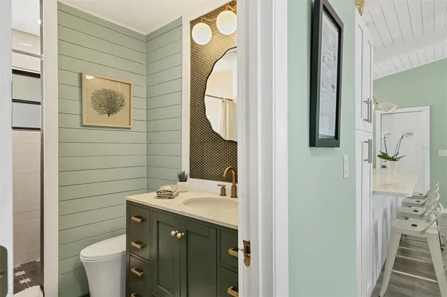a bathroom with a sink mirror and toilet