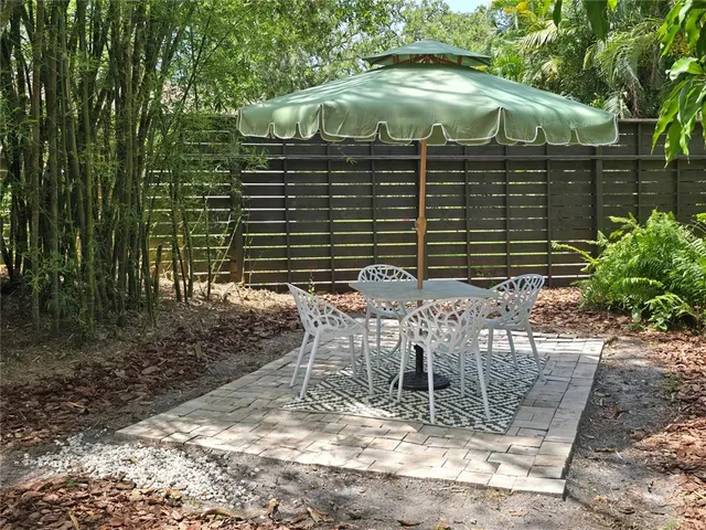 a view of a chair and table in backyard