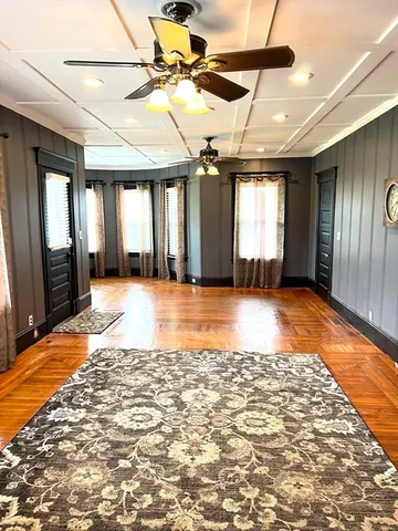 a view of a livingroom with wooden floor and window