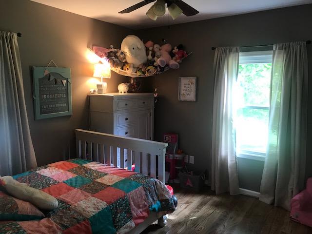 11665 Owens Chapel Road Springfield, TN 37172 - Photo 16 of 25 a bedroom with a bed and wooden floor
