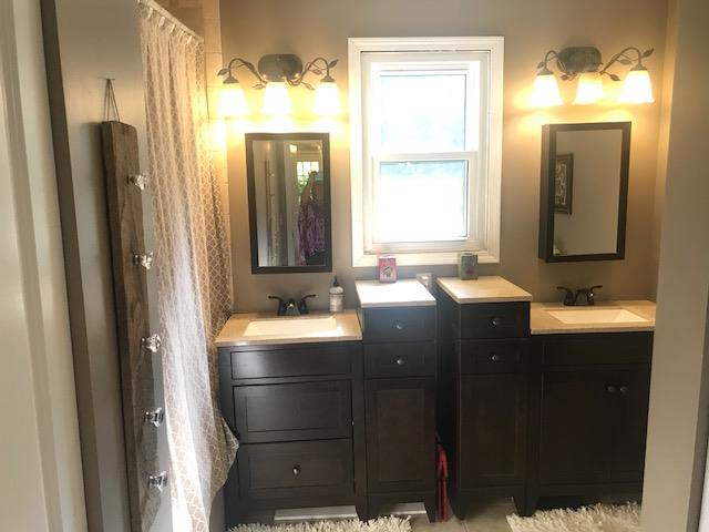 11665 Owens Chapel Road Springfield, TN 37172 - Photo 17 of 25 a bathroom with a double vanity sink and mirror