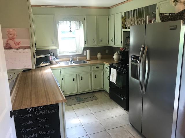 11665 Owens Chapel Road Springfield, TN 37172 - Photo 9 of 25 a kitchen with stainless steel appliances granite countertop a refrigerator a sink a stove and island