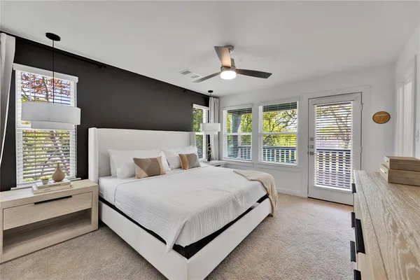 a spacious bedroom with a bed and a large window