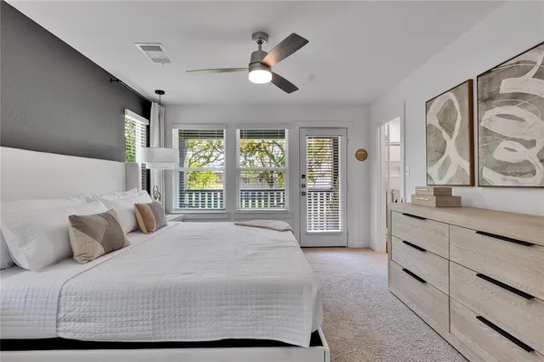 a bedroom with a large bed and a large window