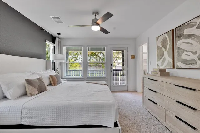 a bedroom with a large bed and a large window