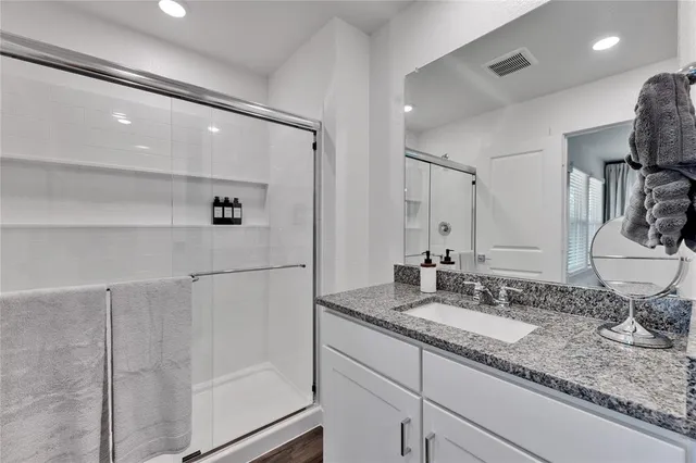 a spacious bedroom with a large bed and a large window