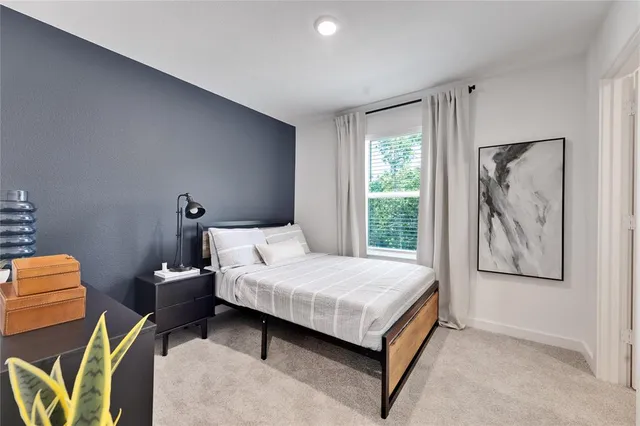 a bedroom with furniture and a window