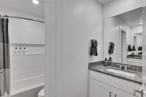 a bathroom with a bathtub and shower