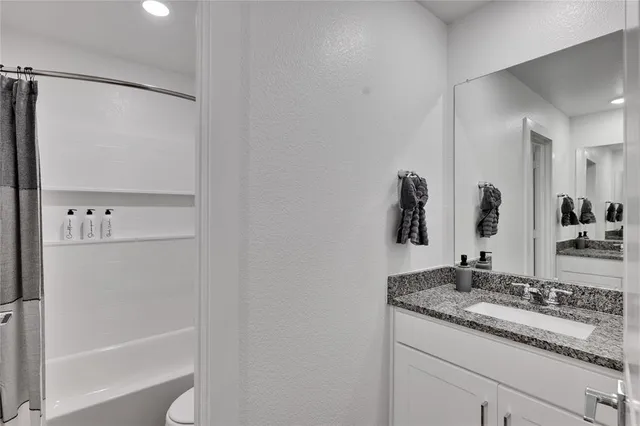 a bathroom with a bathtub and shower