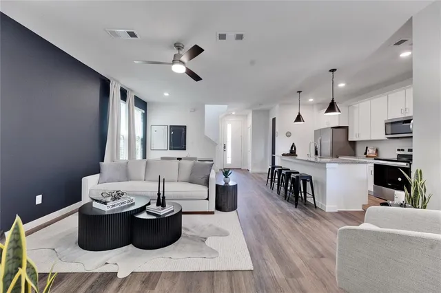 a living room with furniture and a kitchen
