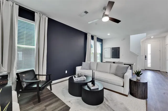 a living room with furniture and a large window