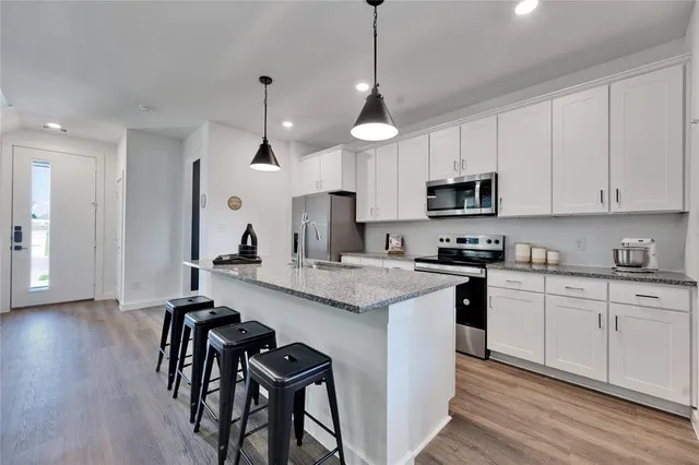a view of living room with granite countertop furniture and wooden floor