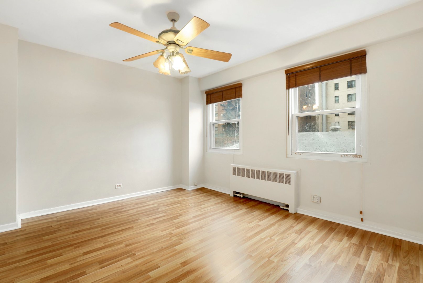 Undisclosed Address Chicago, IL 60657 - Photo 11 of 18 a view of an empty room with wooden floor and a window