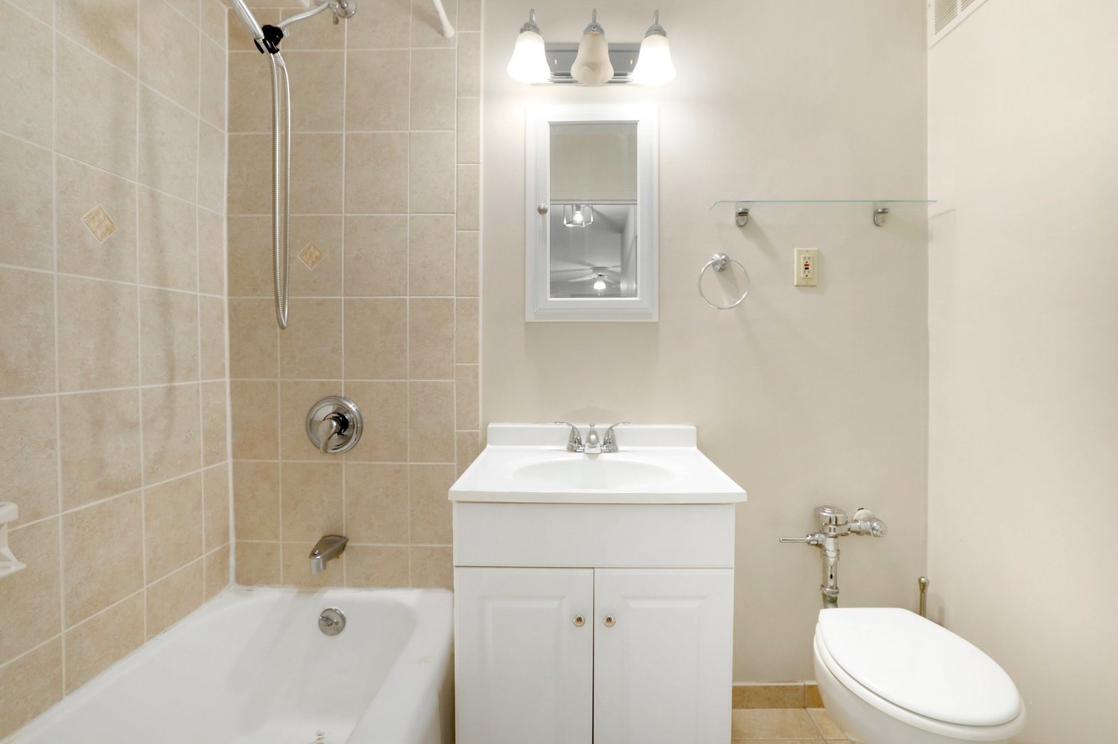 Undisclosed Address Chicago, IL 60657 - Photo 14 of 18 a bathroom with a sink a toilet and shower