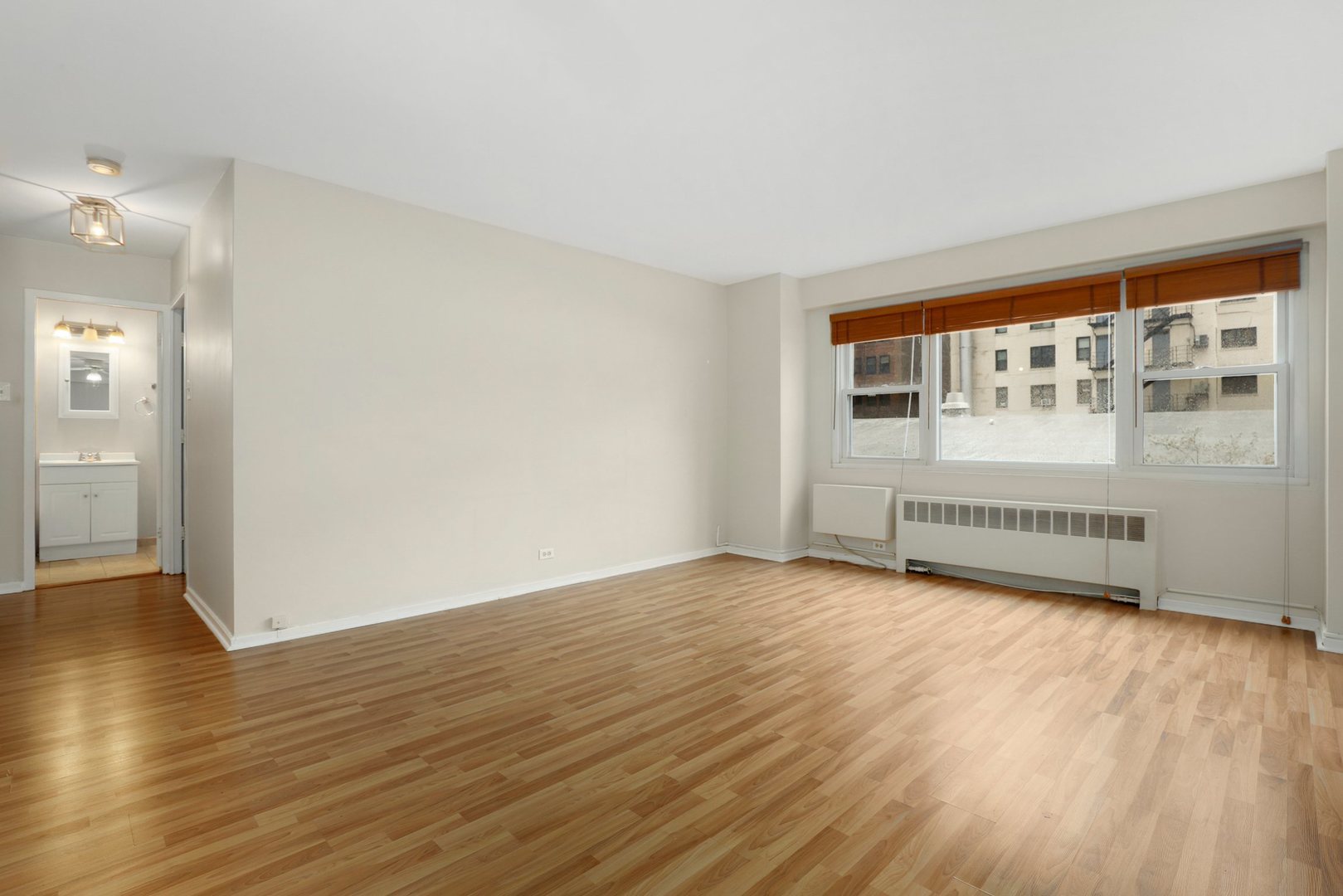 Undisclosed Address Chicago, IL 60657 - Photo 6 of 18 wooden floor in an empty room with a window