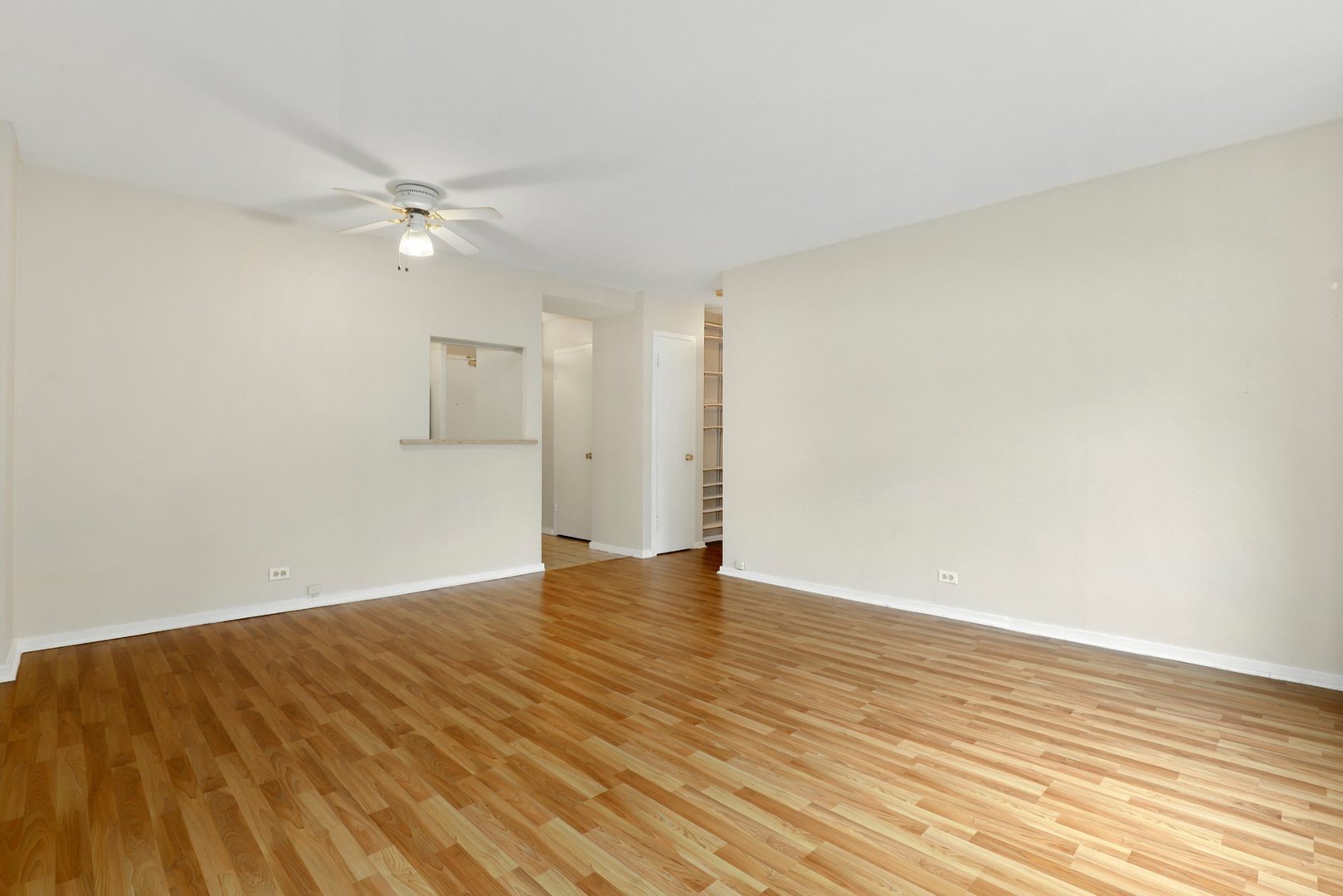 Undisclosed Address Chicago, IL 60657 - Photo 7 of 18 a view of empty room with wooden floor and fan