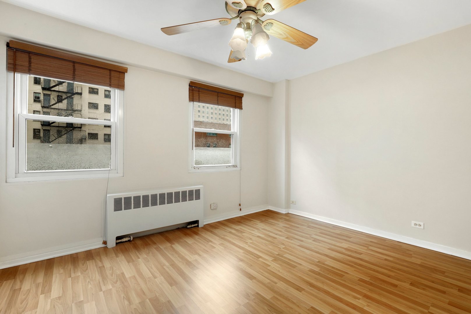 Undisclosed Address Chicago, IL 60657 - Photo 10 of 18 an empty room with wooden floor fan and windows