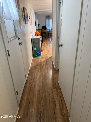 a view of hallway with wooden floor