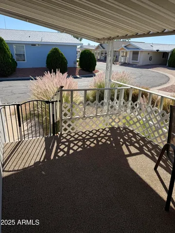 a view of a porch with furniture and a yard