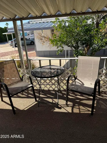 a view of a chairs and table in the patio