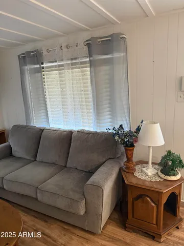 a living room with furniture and a window