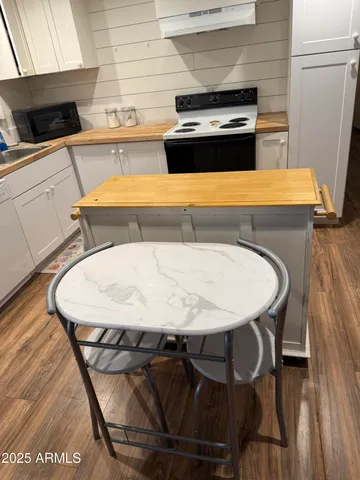 a kitchen with a table chairs and a stove