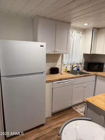 a kitchen with a refrigerator and a sink
