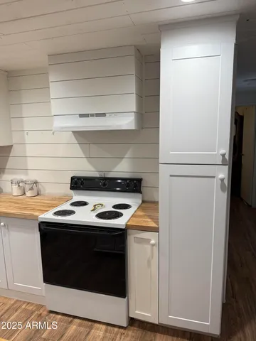 a stove top oven sitting inside of a kitchen