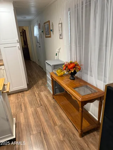 a living room with a table chairs and wooden floor