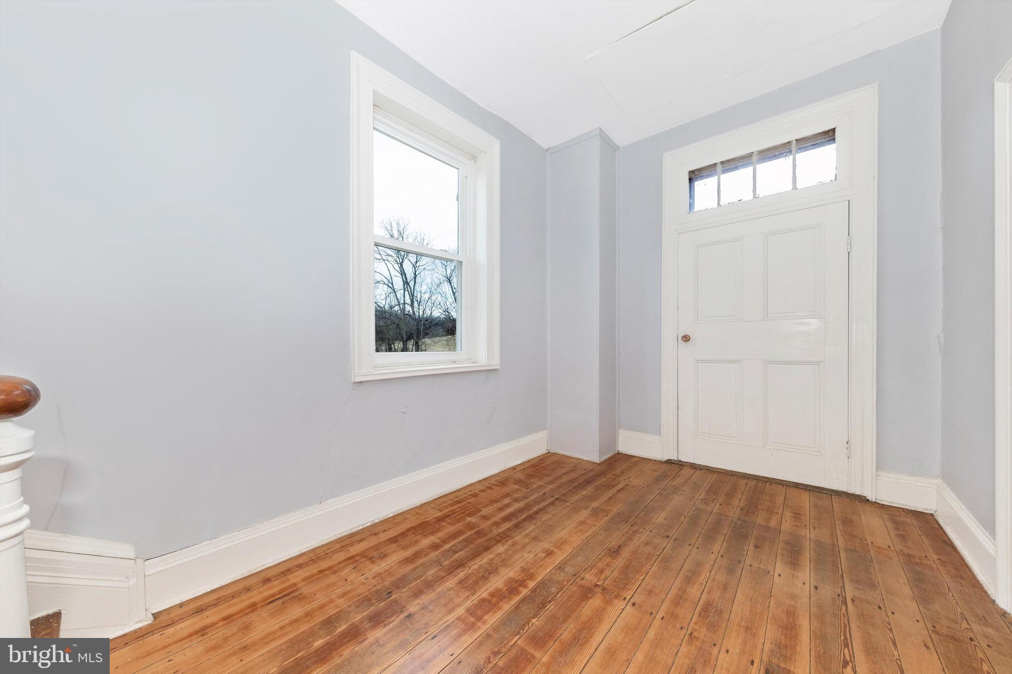 2820 Milt Summers Road Middletown, MD 21769 - Photo 24 of 88 an empty room with wooden floor and windows