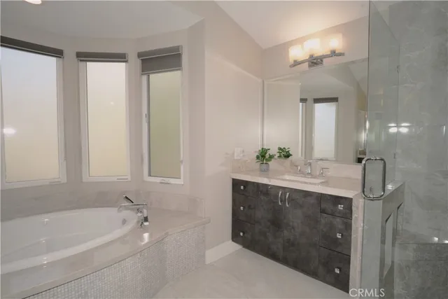 a bathroom with a bathtub sink and mirror