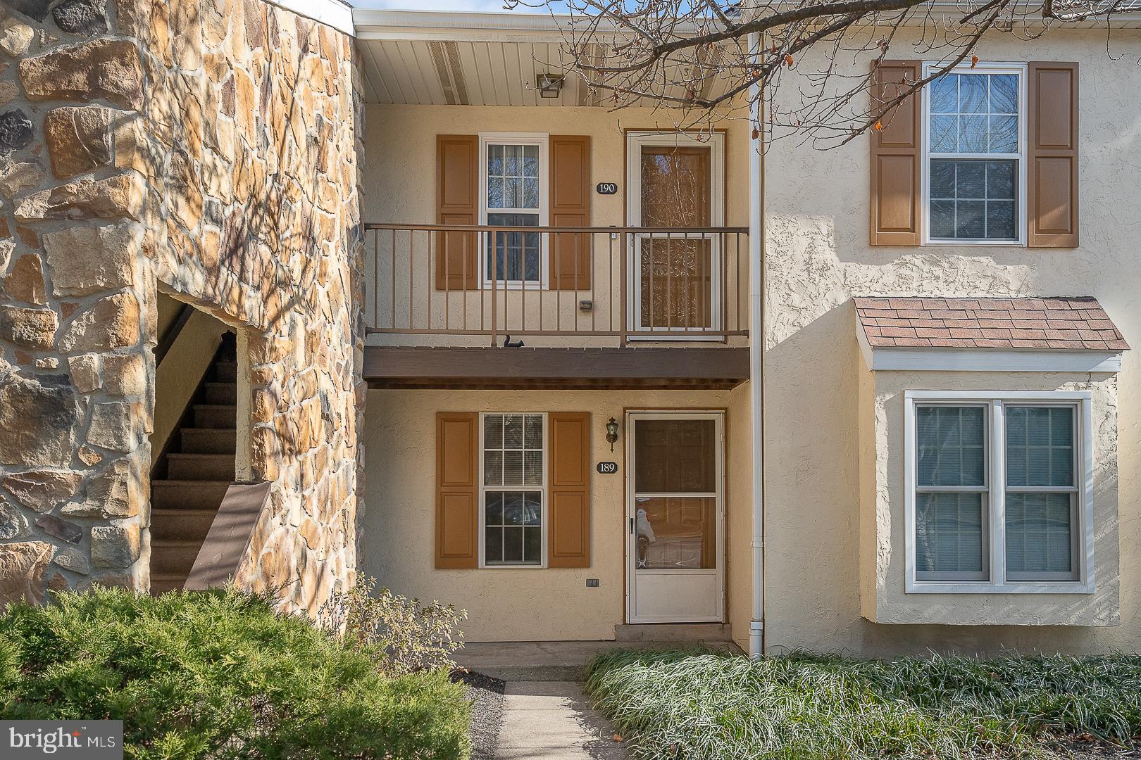 a view of a brick house with large windows