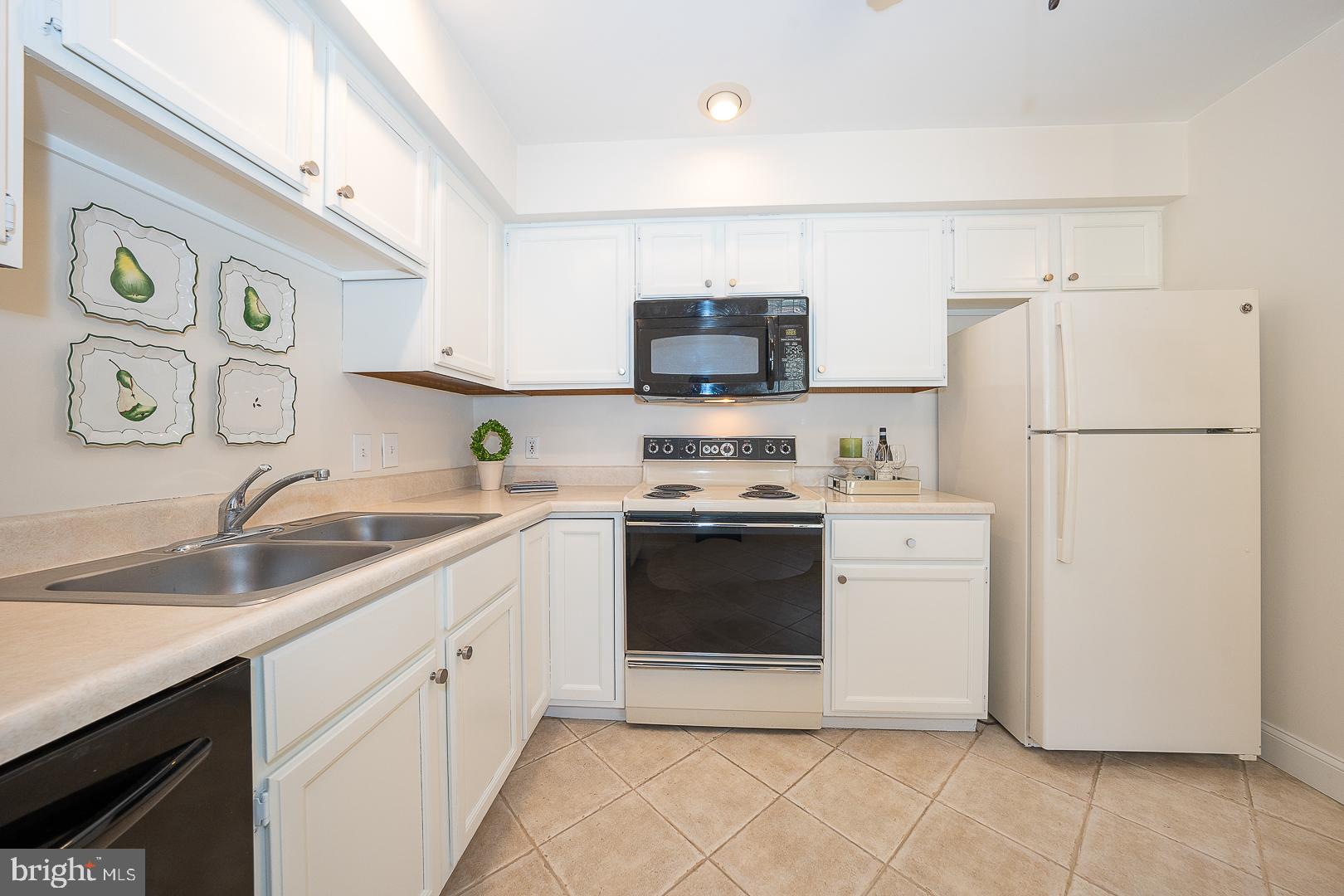 189 Valley Stream Lane Chesterbrook, PA 19087 - Photo 11 of 22 a kitchen with a refrigerator sink and white stove