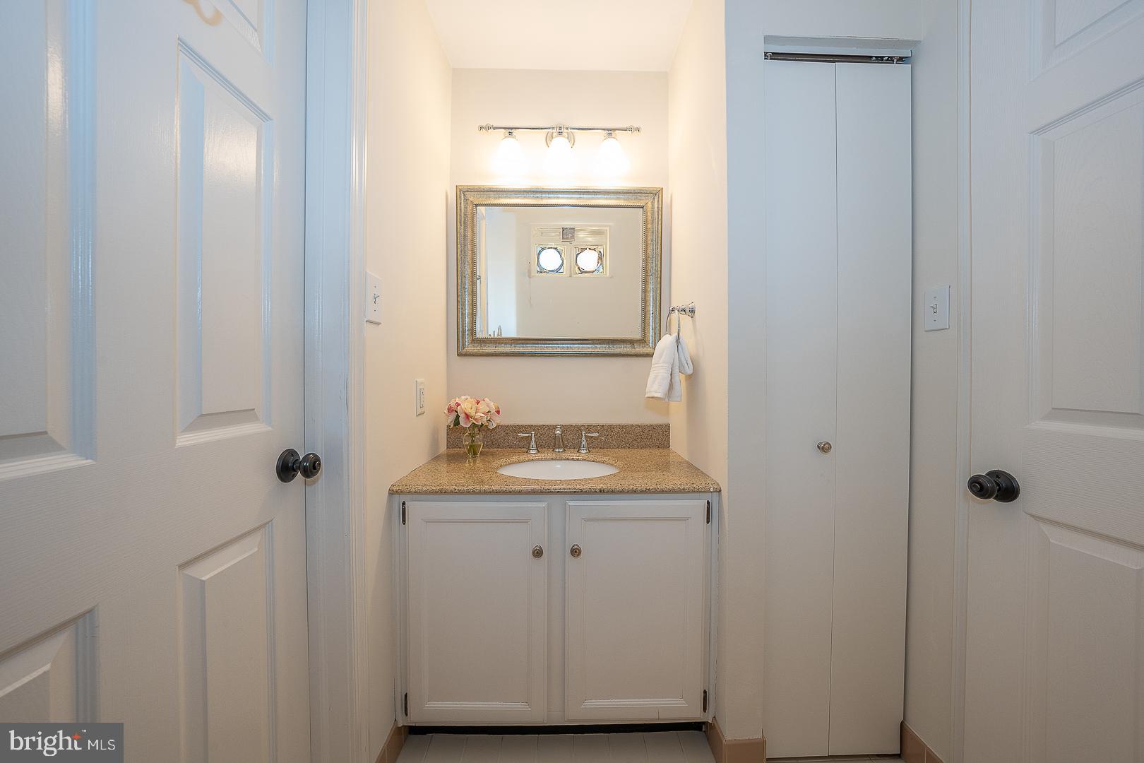 189 Valley Stream Lane Chesterbrook, PA 19087 - Photo 17 of 22 a bathroom with a granite countertop sink and a mirror