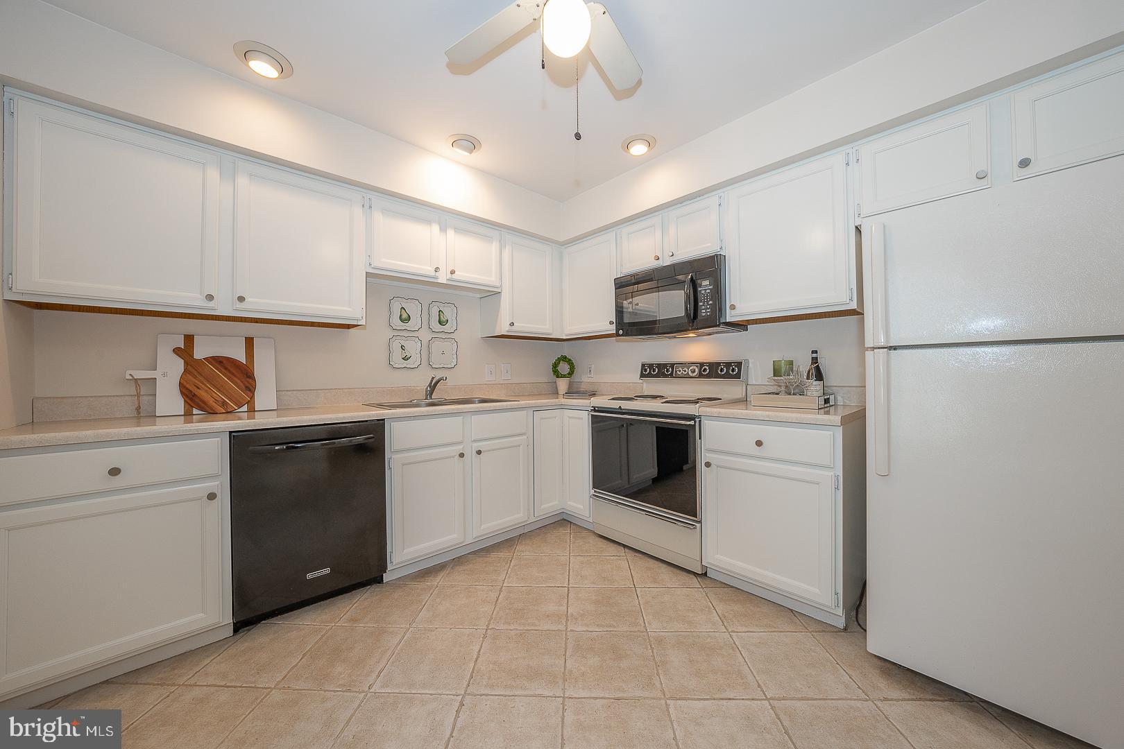 189 Valley Stream Lane Chesterbrook, PA 19087 - Photo 9 of 22 a kitchen with a refrigerator sink and cabinets